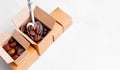 Small cardboard boxes with coffee beans and spoon