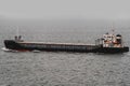 Small cargo ship sailing through dense fog at sea Royalty Free Stock Photo