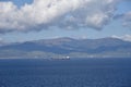 Small cargo ship sailing near sea coast close to Gibraltar. Royalty Free Stock Photo