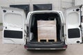 A small cargo van with cargo on a pallet in the car