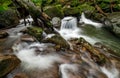 Small cascade on the river among bouders in forest