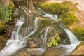 Small cascade in wild natural stream.