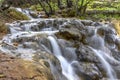 Small cascades of waterfalls on a mountain stream in the spring. Parod River. Israel Royalty Free Stock Photo