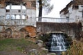 A small cascading waterfall near the ruins of an ancient house Royalty Free Stock Photo