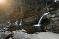 Small cascading waterfall among the rocks and forest. Beautiful mountain landscape. Copy, empty space for text Royalty Free Stock Photo