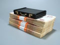 Small case laying on big stack of Russian five thousand ruble banknotes, gray background