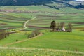 Small catholic church on hilltop surrounded by green agricultural field Royalty Free Stock Photo