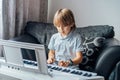 Small caucasian boy playing electric piano making music at home leisure activity growing up education and art concept playful Royalty Free Stock Photo