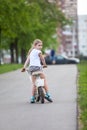 Small Caucasian girl riding a bicycle in park