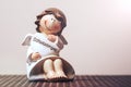 A small ceramic guardian angel holds a heart with an inscription in German schutzengel Royalty Free Stock Photo