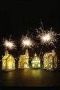 Small ceramic houses with sparklers