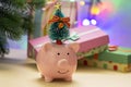 A small ceramic piggy bank with a tree on its head. Symbol of the new year 2019. In the background in a blur of a New Royalty Free Stock Photo