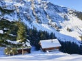 Small chalet covered with snow in Swiss alps Royalty Free Stock Photo