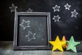 small chalkboard with handwritten star ratings surrounded by chalk dust