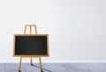 Small chalkboard on a wooden easel inside the classroom