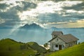 Small chapel with beautiful Mount Pilatus and Lake Lucerne in background as seen from Mount Rigi peak Royalty Free Stock Photo