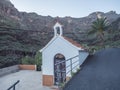 Small chapel at Guarimiar village. At hiking trail through Barranco de Guarimiar Gorge. Green mountain canyon slopes