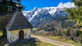 A small chapel with a panoramic view on Baeren Valley in Austrian Alps. The highest peaks in the chain are snow-capped Royalty Free Stock Photo