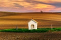 The small chapel surrounded by wheat fields during sunset. Beautiful colorful spring landscape in South Moravia, Czech Republic Royalty Free Stock Photo