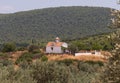 Small chapel in village among olive trees in Greece Royalty Free Stock Photo