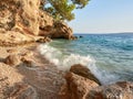 A small, charming pebble beach hidden under a cliff in the Croatian town of Brela. The turquoise waves of the Adriatic Sea