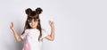 A small cheerful girl, in dark glasses in a White Studio. Stands with his hands raised and shows the peace gesture.