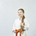 A small cheerful sportswoman in karategi