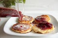 Small cheesecakes with raspberry jam Royalty Free Stock Photo