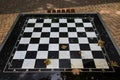 A small chess table in the park. Empty board game table Royalty Free Stock Photo