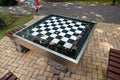 A small chess table in the park. Empty board game table Royalty Free Stock Photo