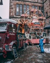 A small child admiring a food truck on christmas