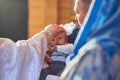 A small child at a baby christening ceremony in a church. the godfather holds a little boy in his arms. Baptism of a