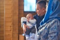 A small child at a baby christening ceremony in a church. the godfather holds a little boy in his arms. Baptism of a