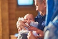 A small child at a baby christening ceremony in a church. the godfather holds a little boy in his arms. Baptism of a