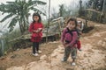 A small child in a bag behind a teenage girl. Red dzao - a small nation of North Vietnam