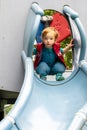 Small child on a big slide Royalty Free Stock Photo