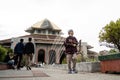 A small child brings packaged food from the Gadjah Mada University mosque