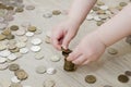 Child builds a tower of coins