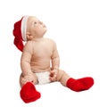 A small child in a Christmas hat and boots Royalty Free Stock Photo