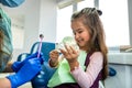 A small child at a dentist's appointment, the doctor shows and tells how to brush your teeth