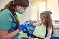 A small child at a dentist's appointment, the doctor shows and tells how to brush your teeth