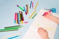 a small child draws with a pink felt-tip pen in an album, Royalty Free Stock Photo