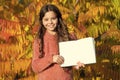 Small child enjoy reading autumn foliage background. Little child enjoy learning in autumn park. Kid study with book