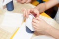 Small child hands glue paper crafts at school desk Royalty Free Stock Photo