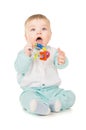 A small child holding a toy in his mouth Royalty Free Stock Photo