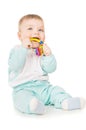 A small child holding a toy in his mouth Royalty Free Stock Photo