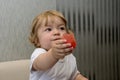 A small child holds out a piece of watermelon, treats people, generous person, children`s kindness Royalty Free Stock Photo