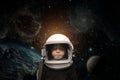 A small child imagines himself to be an astronaut in an astronaut`s helmet