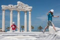 Small child jumps over the ancient roman ruins in front of the r