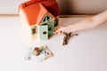 small child, with keys in hand, trying to open the door of the toy house Royalty Free Stock Photo